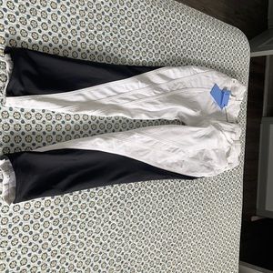 Black and white Mugler jeans with leggings on the back side